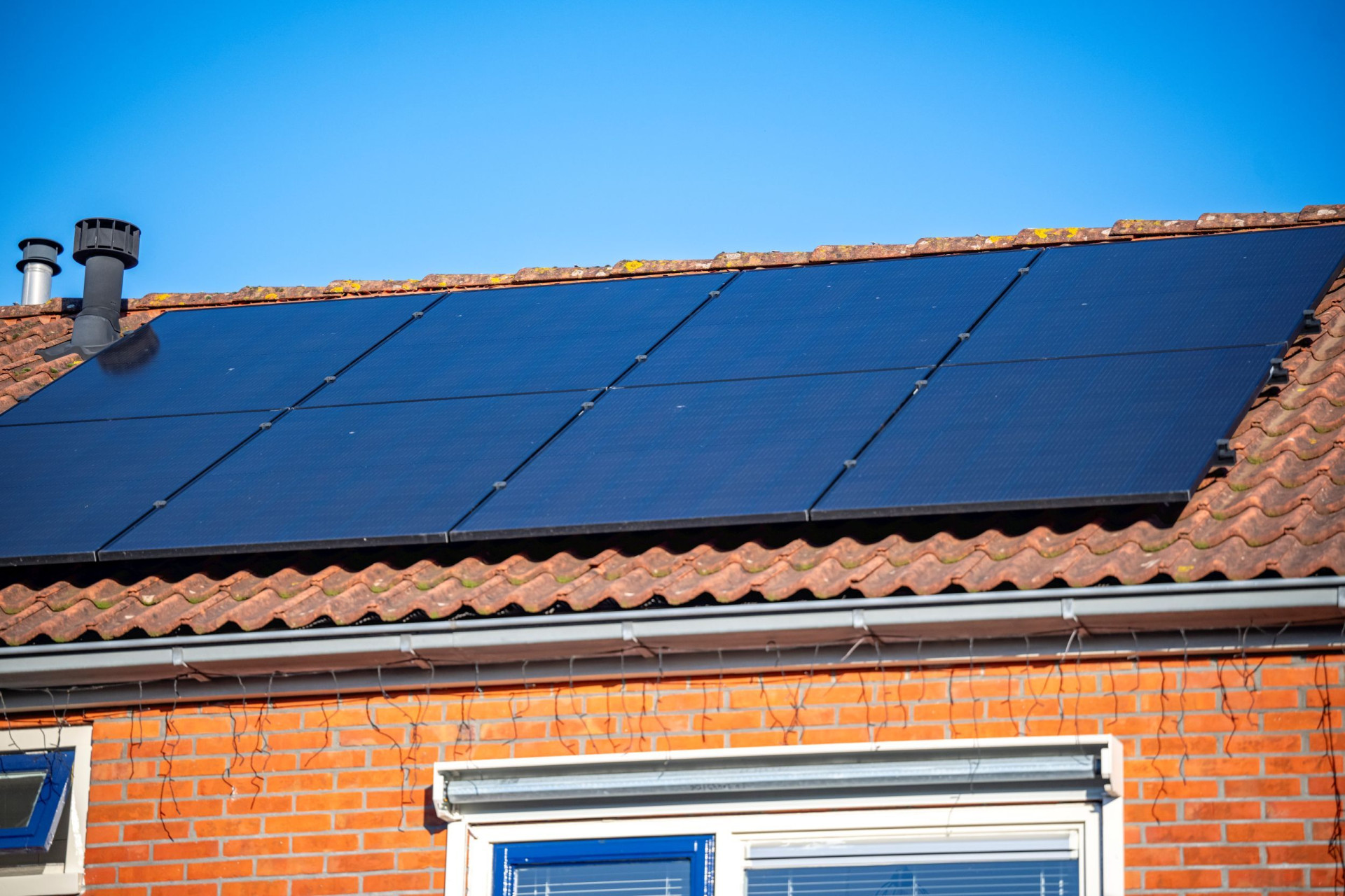 Zonnepanelen op een pannendak van een huis.